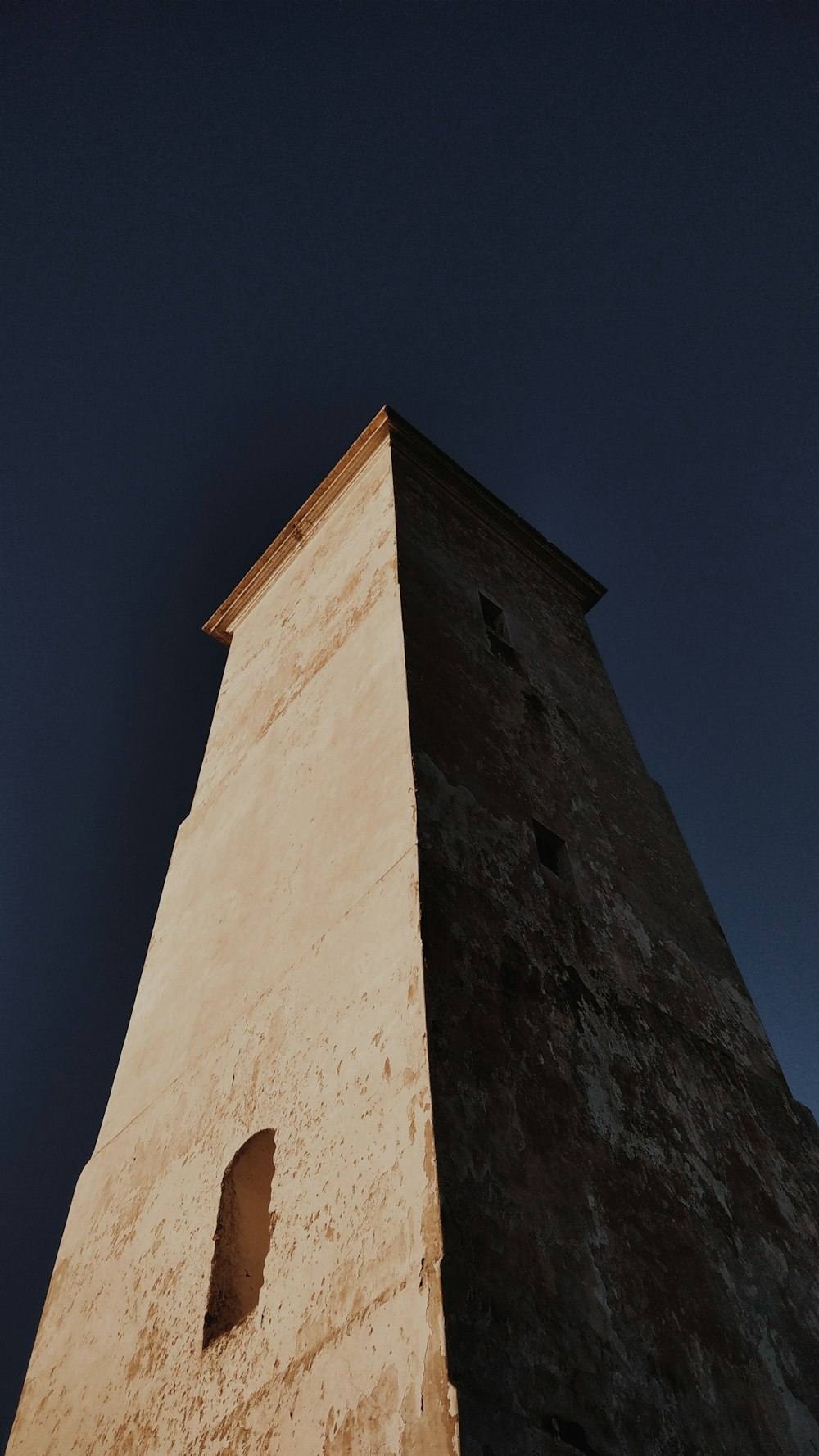 low angle photography of gray concrete tower