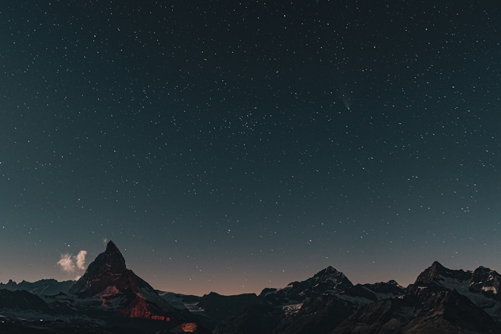 snow covered mountain during night time