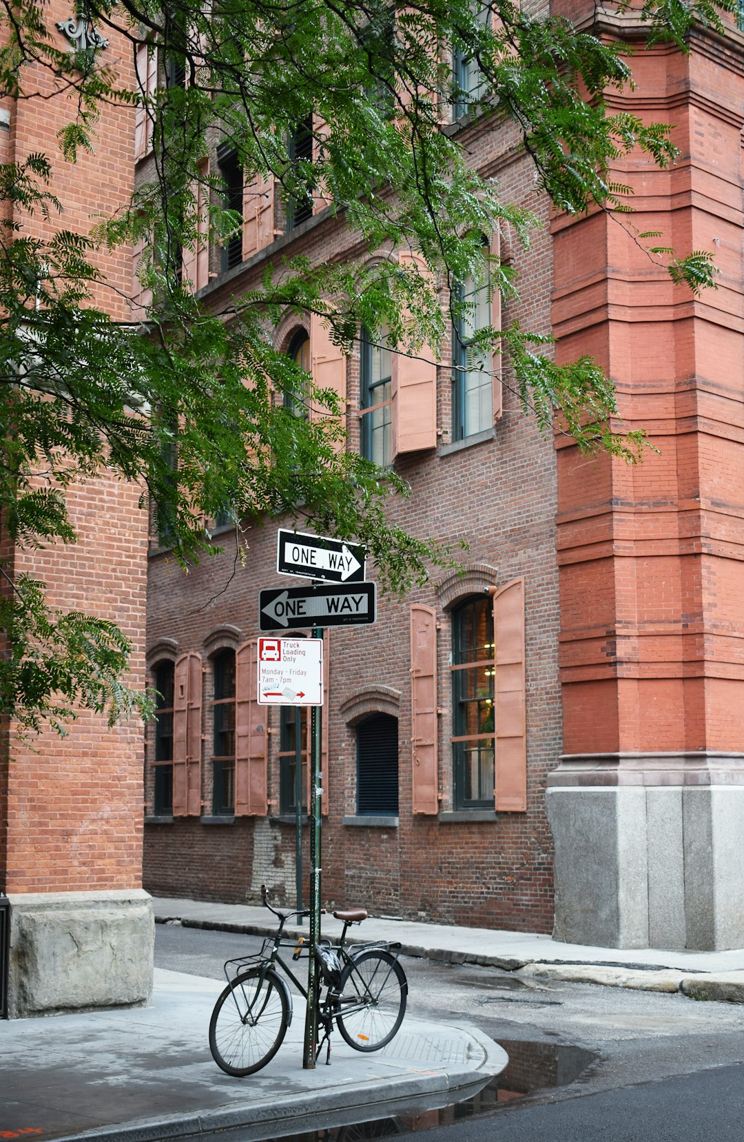 brown brick building with green trees