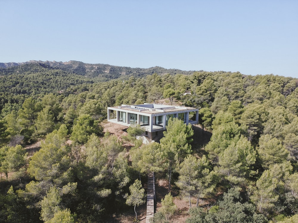 white and brown concrete building on green mountain during daytime