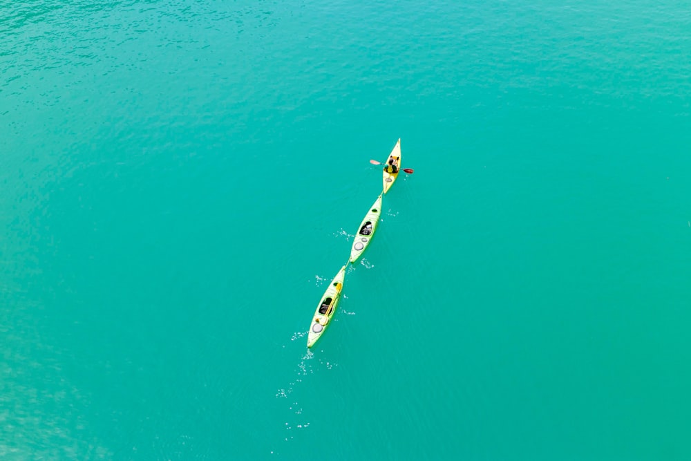 person in white and blue surfing board in the middle of the sea during daytime