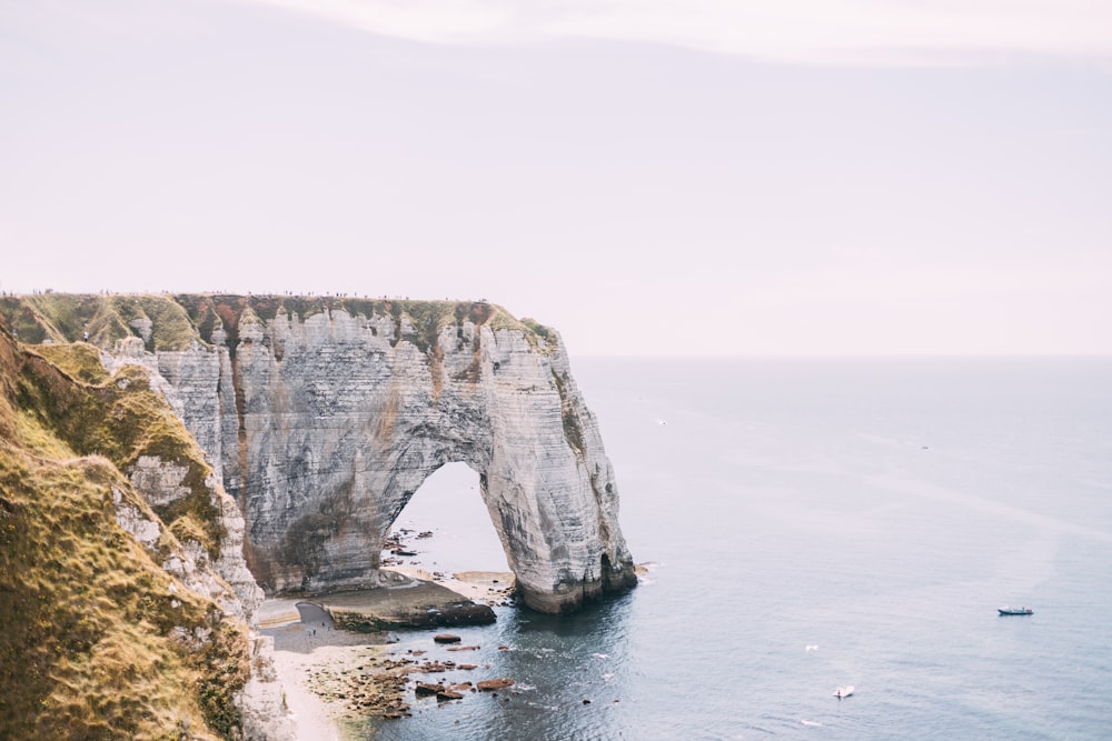 gray rock formation on sea during daytime