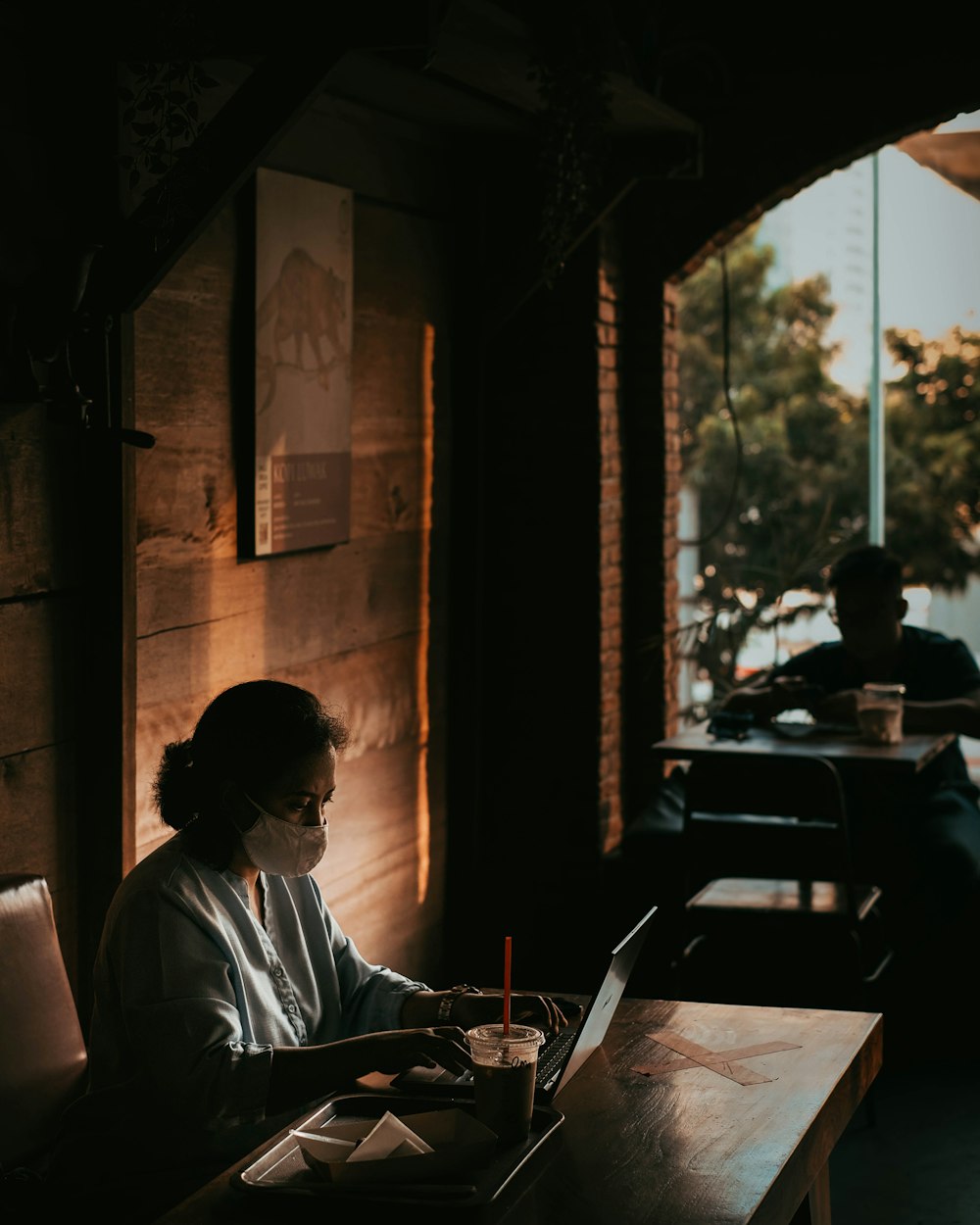 man in gray dress shirt sitting on chair