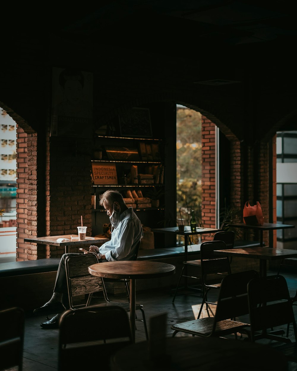 man in white dress shirt sitting on chair