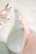 A close-up of elegant lingerie draped over a soft surface.
