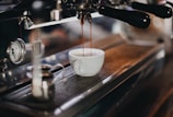 white ceramic cup on brown wooden table