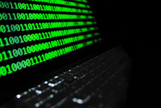 black laptop computer turned on with green screen