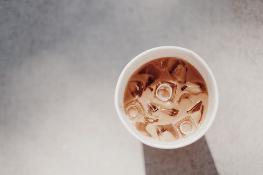 white plastic cup with brown liquid