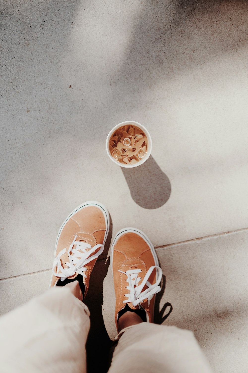 person wearing brown and white sneakers