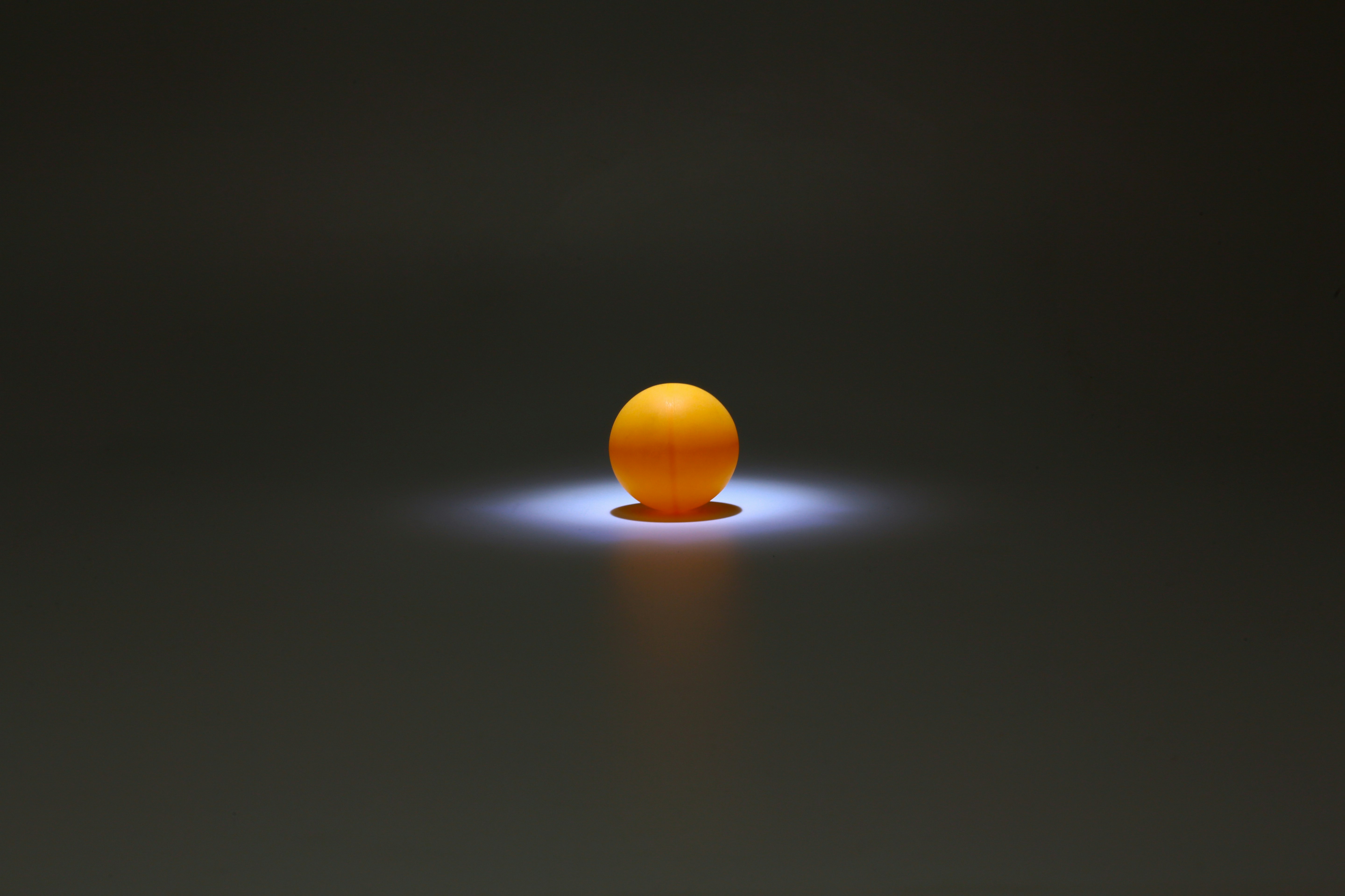 yellow ball on black surface