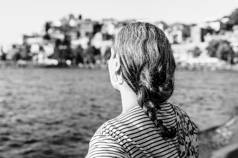 grayscale photo of woman in stripe shirt