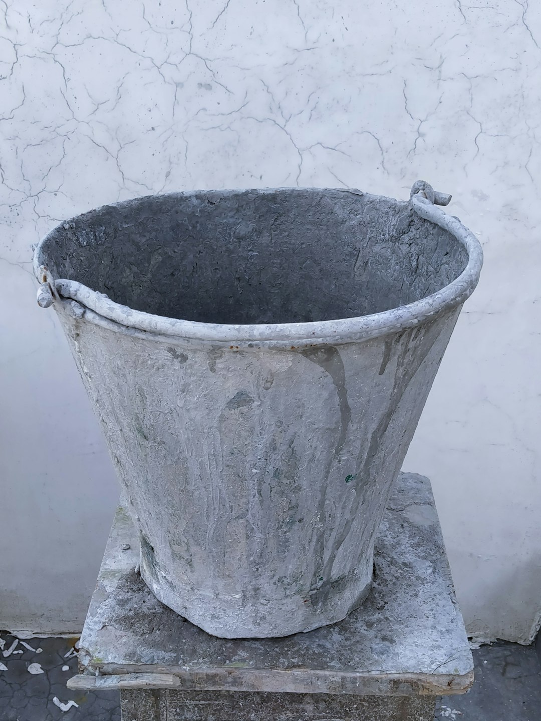  gray concrete bucket on gray concrete floor bucket