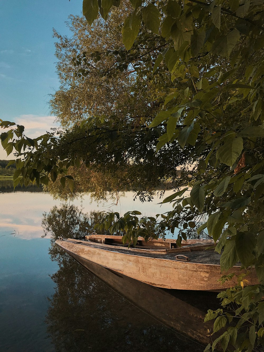 brown boat on lake during daytime