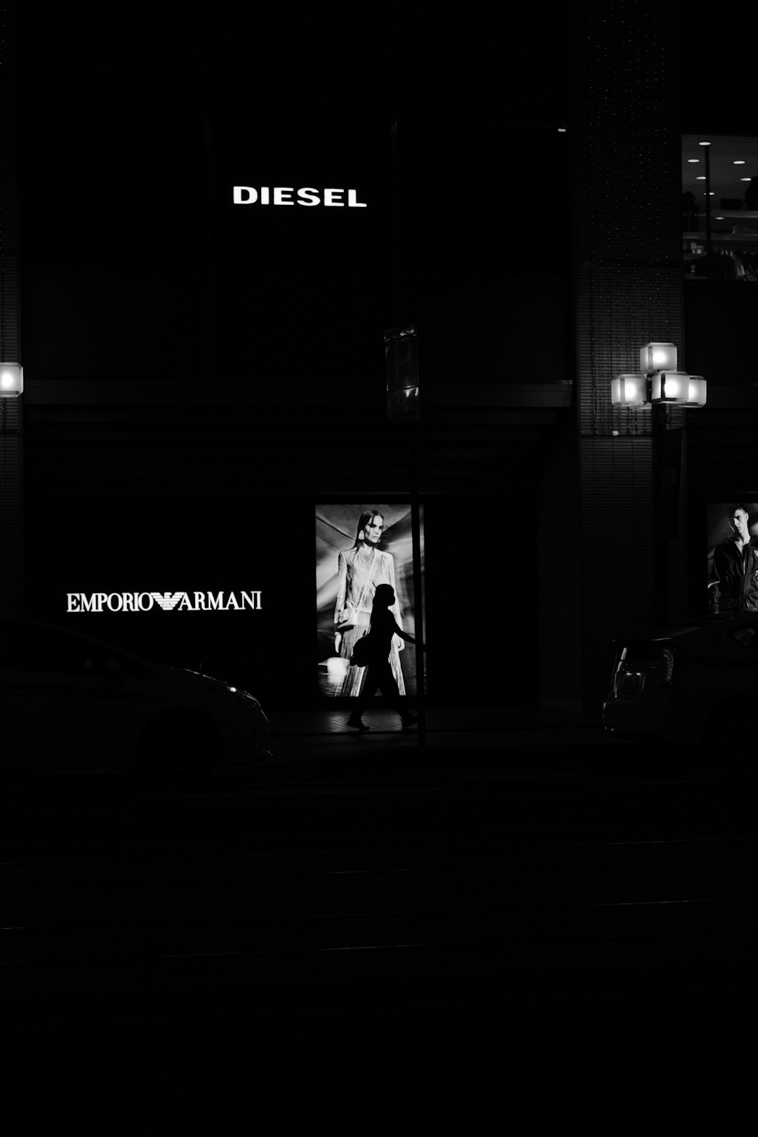 man in black suit standing near building