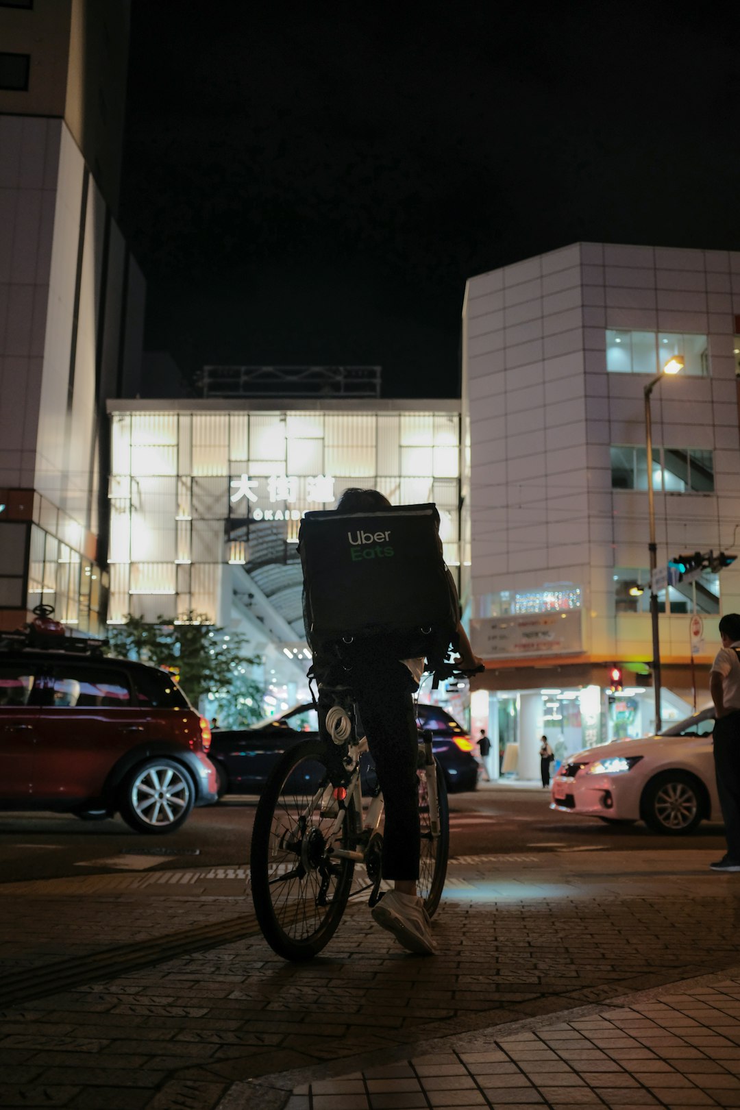 black bicycle parked beside black car