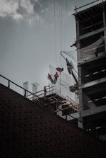 Construction workers collaborating on a commercial building site with safety gear.