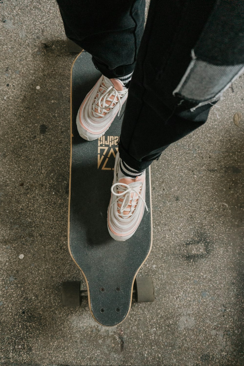 person in black pants and gray and white sneakers