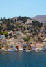 houses on mountain near body of water during daytime