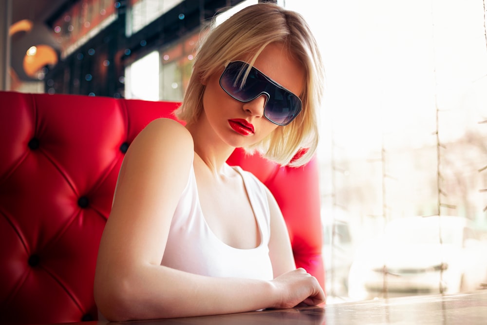 woman in white tank top wearing black sunglasses