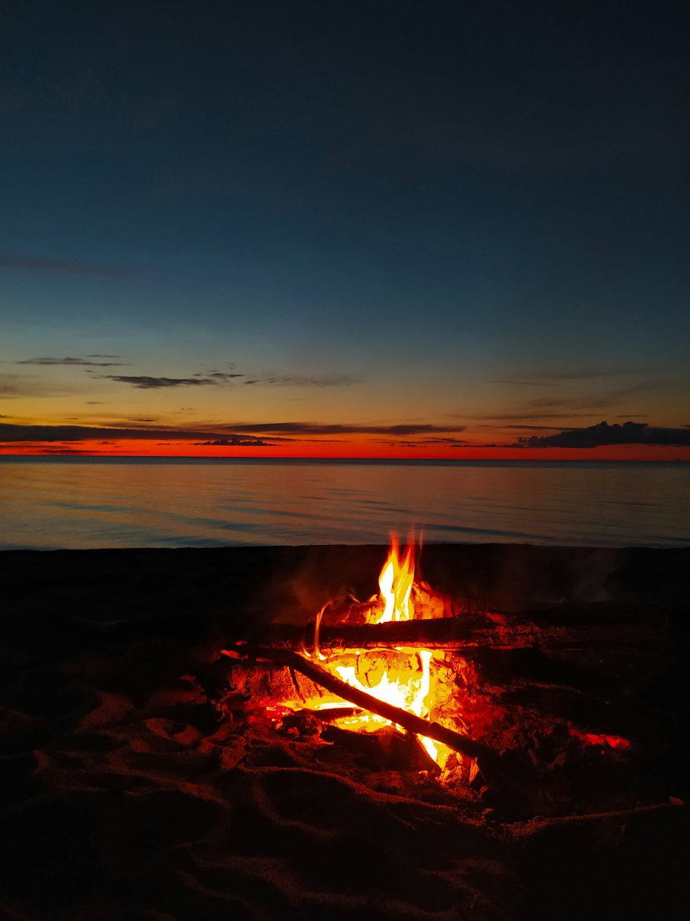 fire on beach during sunset