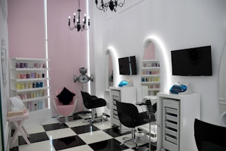 Elegant beauty salon interior with soft pink, white, and gold accents.
