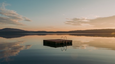 Wooden swimming dock on an Ontario lake, featured in beginner's guide to buying waterfront property.