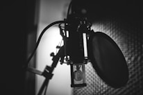 A close-up of a microphone set up for voice-over recording in a soundproof booth.