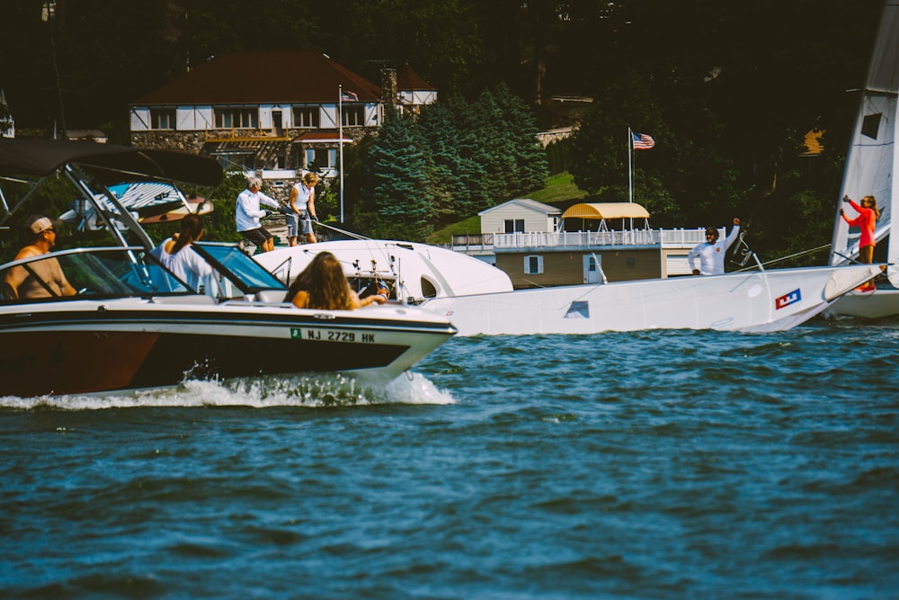 white and blue boat on body of water during daytime