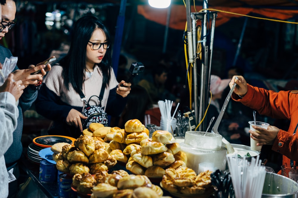 woman in white long sleeve shirt sitting beside brown and white mushrooms