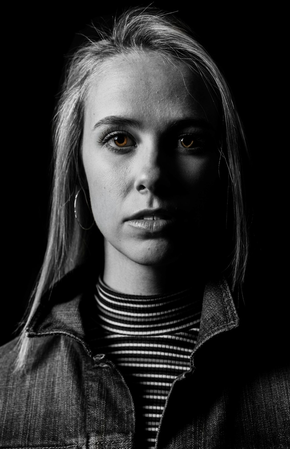 grayscale photo of woman in black and white striped turtleneck shirt