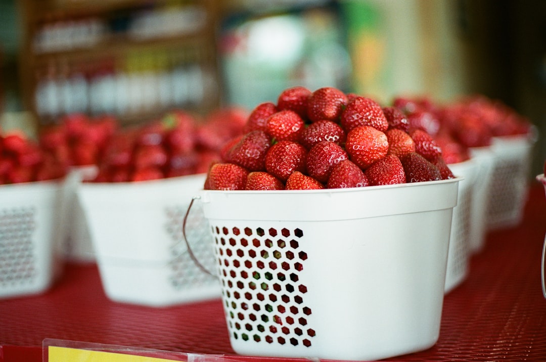 red strawberries in white plastic basket
