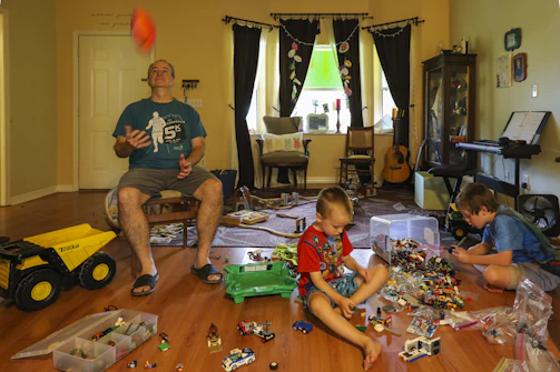 A cheerful family playing with colorful toys in a bright living room