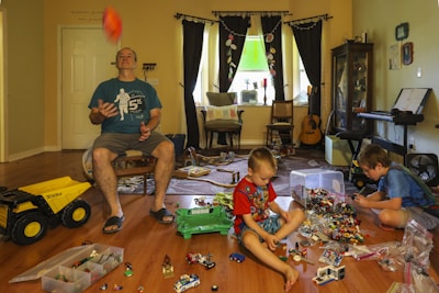 Children playing with colorful toys in a bright and cheerful living room.