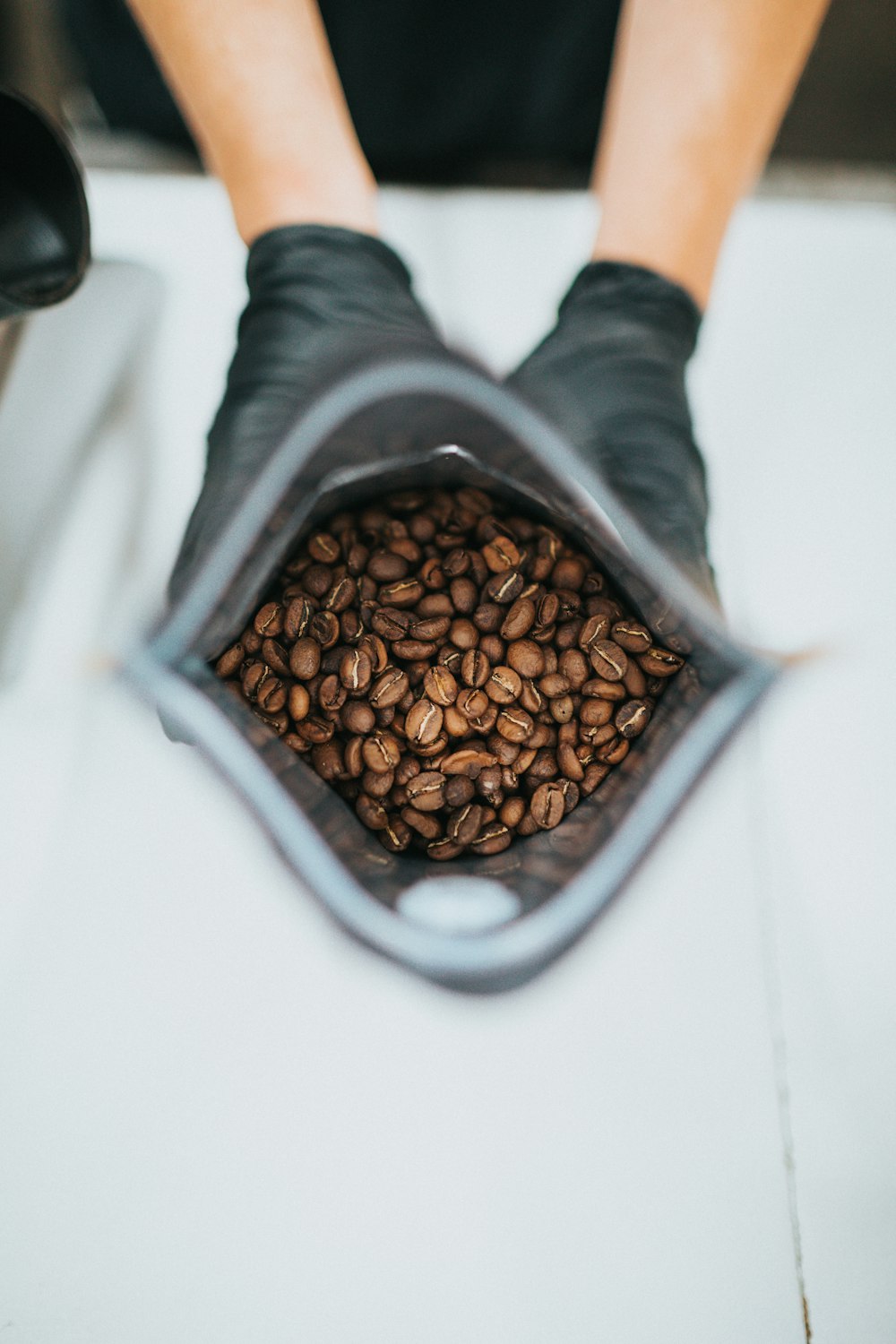 brown coffee beans in gray ceramic bowl