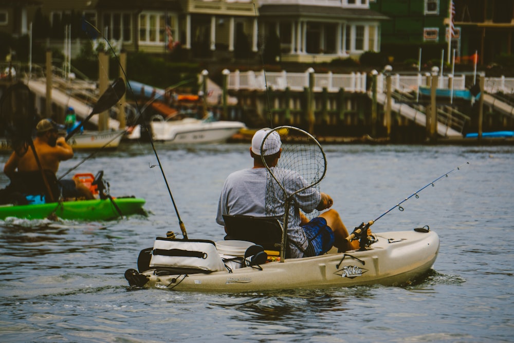 man in black jacket riding yellow and white personal watercraft on water during daytime