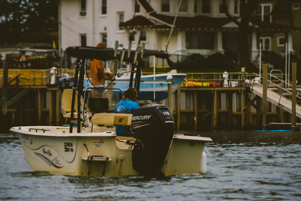 white and blue boat on water during daytime