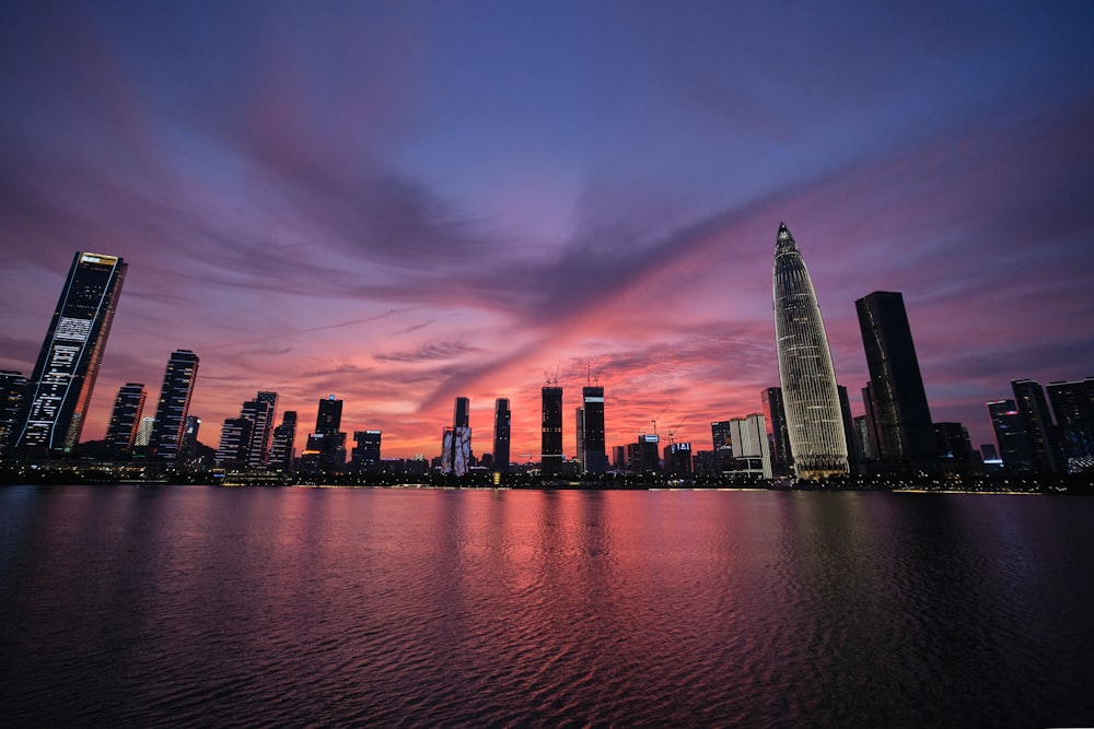 high rise building near body of water during sunset