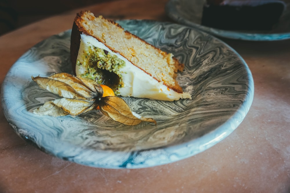 sliced bread with white cream on blue ceramic plate