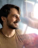 man in white crew neck shirt smiling