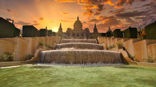 water fountain near concrete building during sunset in Museu Nacional d'Art de Catalunya Spain