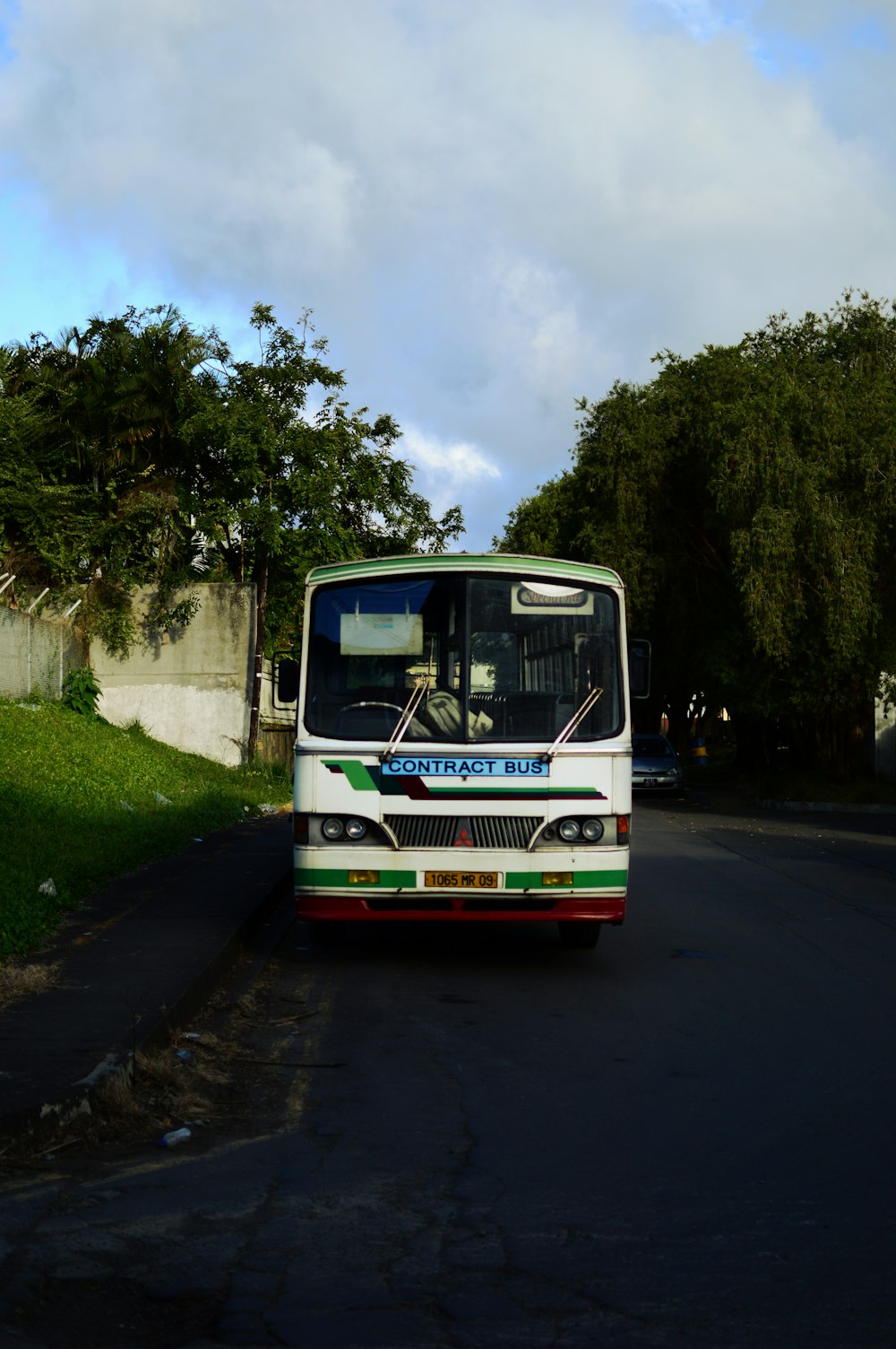 white and red bus on road during daytime