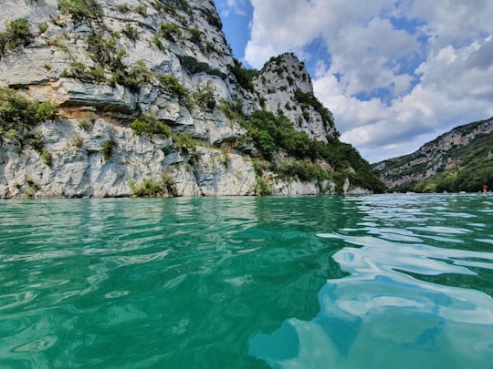gray rocky mountain beside body of water during daytime in Gorges du Verdon France