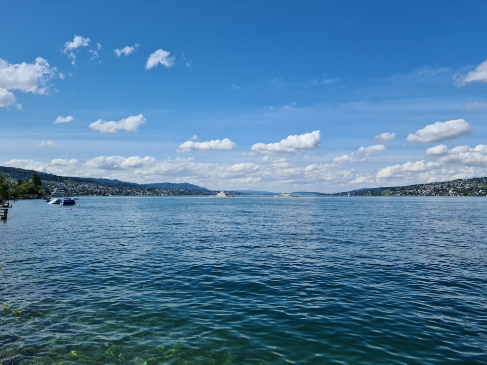 blue sea under blue sky and white clouds during daytime