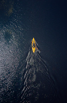 yellow and black surfboard on body of water