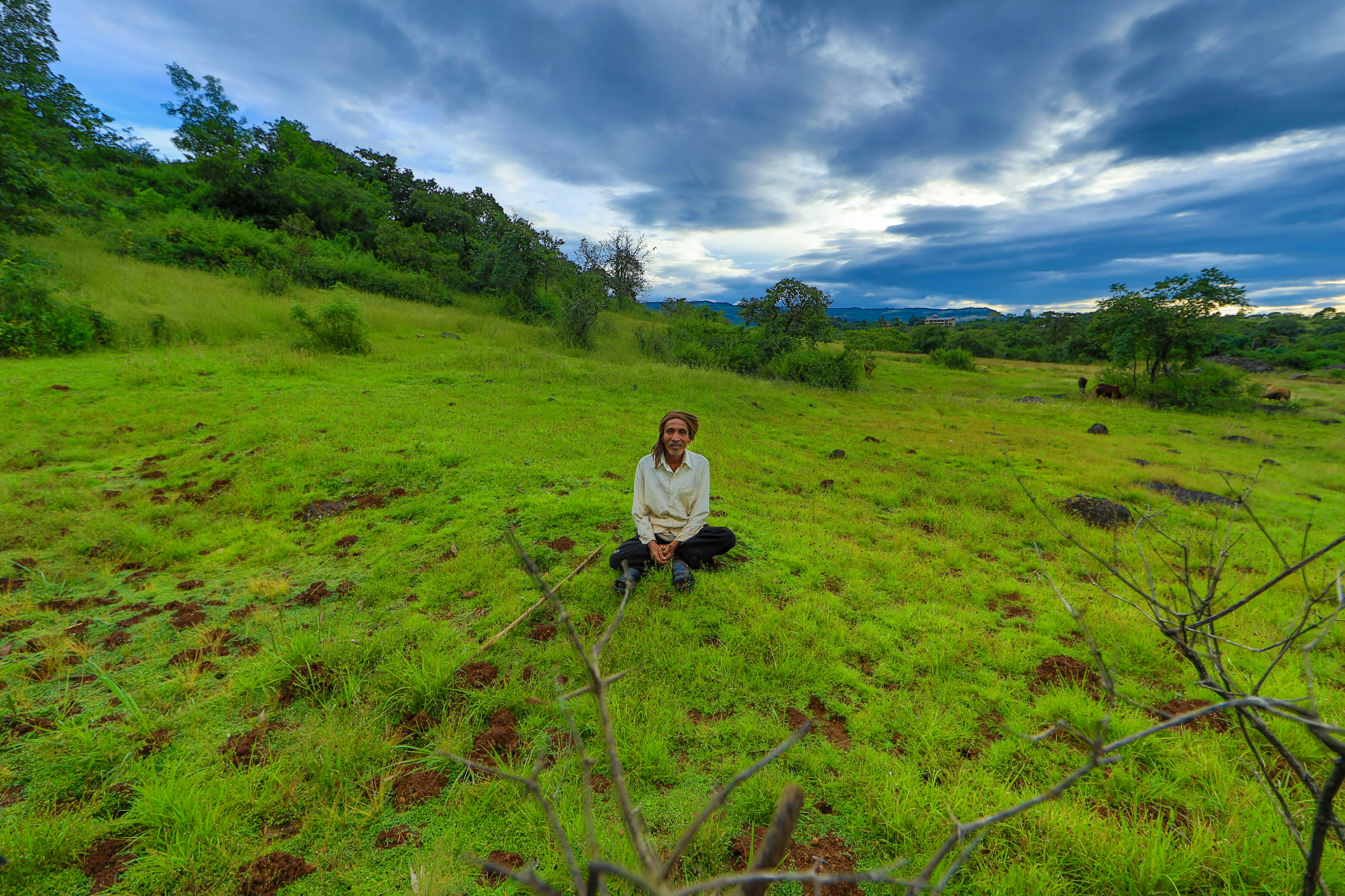 woman in white long sleeve shirt and black pants walking on green grass field during daytime