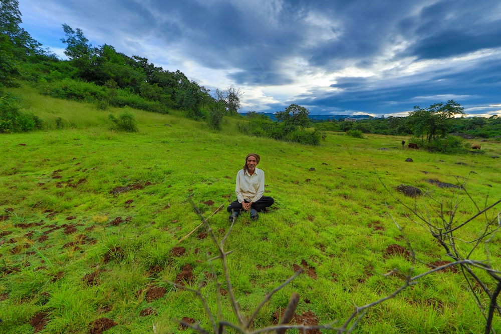 woman in white long sleeve shirt and black pants walking on green grass field during daytime