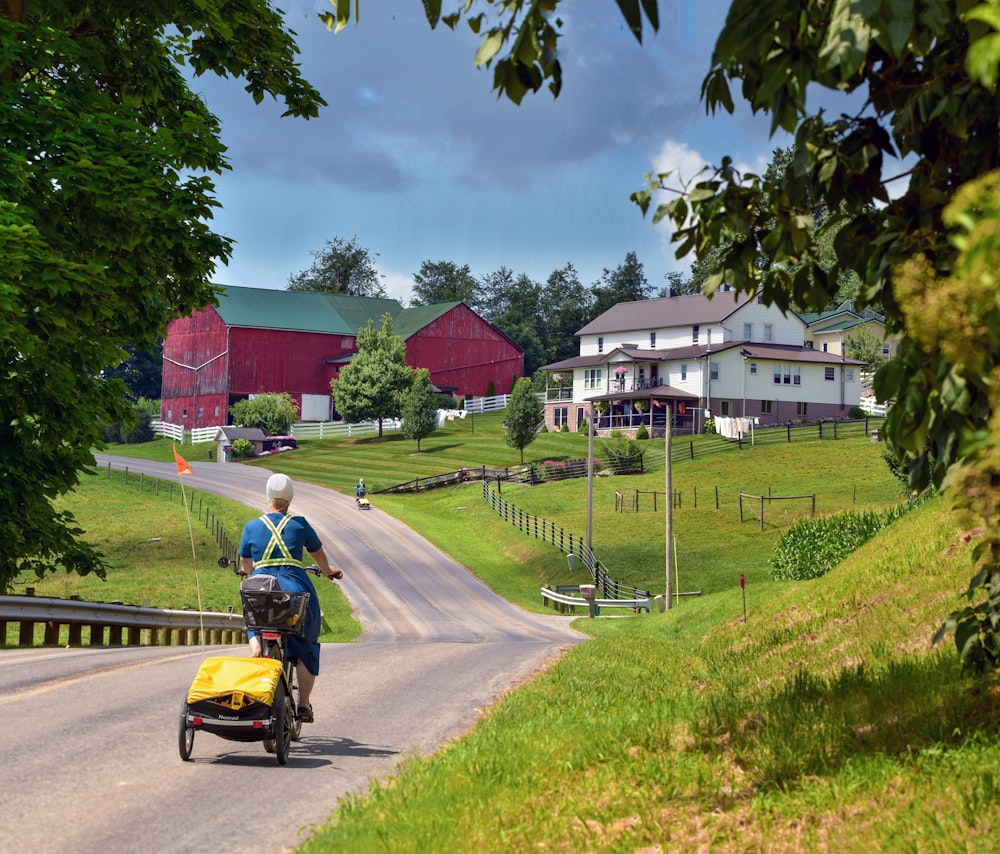 man in blue shirt riding on yellow and black motorcycle