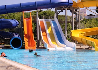 yellow and blue slide on swimming pool