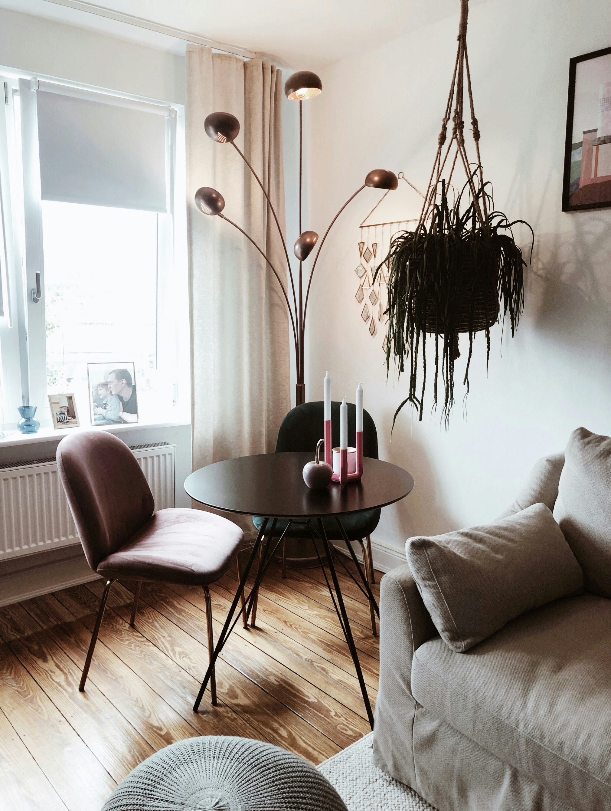 black metal framed brown wooden round table near white sofa