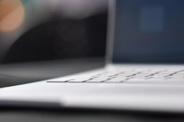 Close-up of hands typing on a sleek keyboard, emphasizing user-friendly technology.